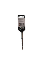 A single metal drill bit with a black and white retail hanger card, photographed on a light gray tabletop. Part of a green and white box is visible in the top-left corner.