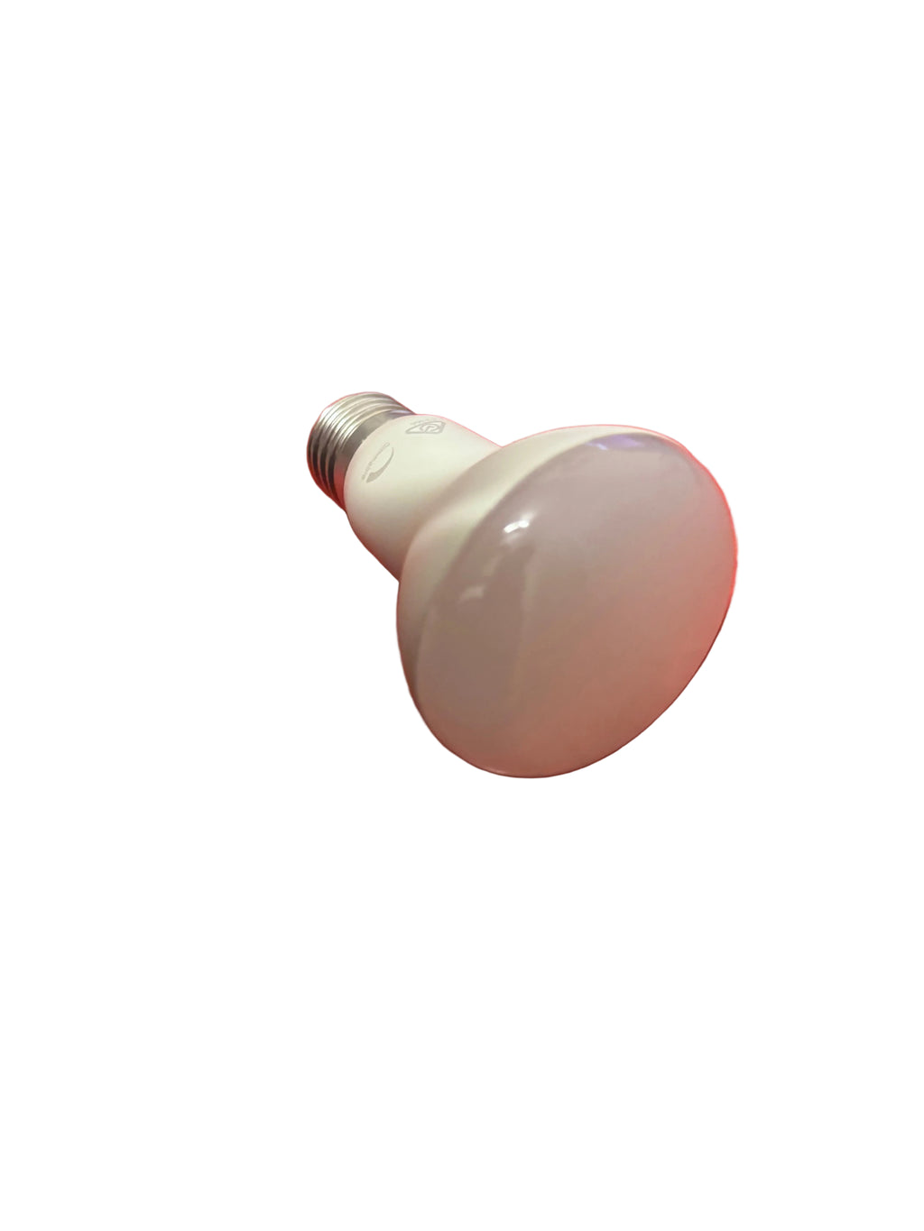 Light bulb on a red textured surface with a laptop in the background